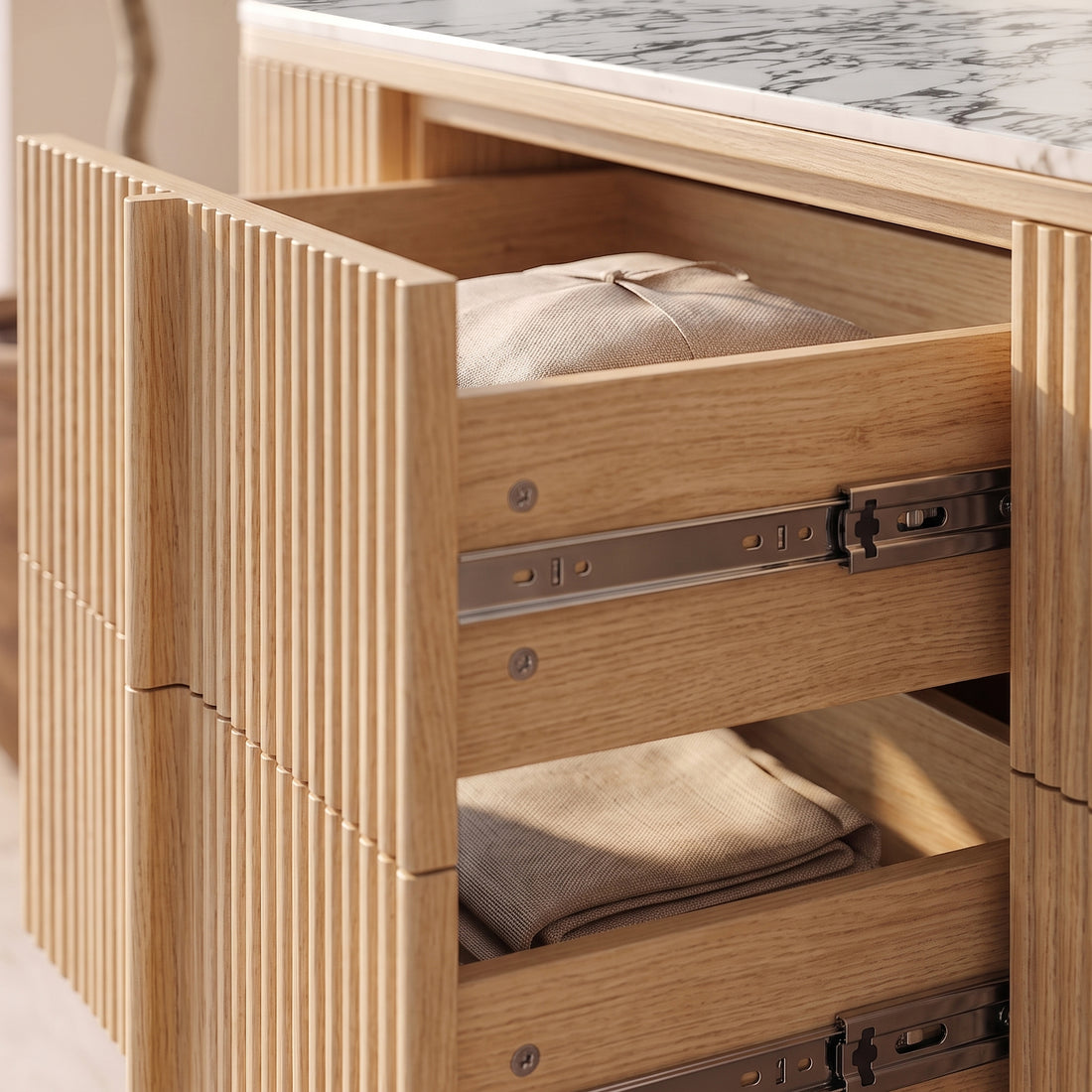 Close-up of open wooden drawers in a sideboard with a marble top