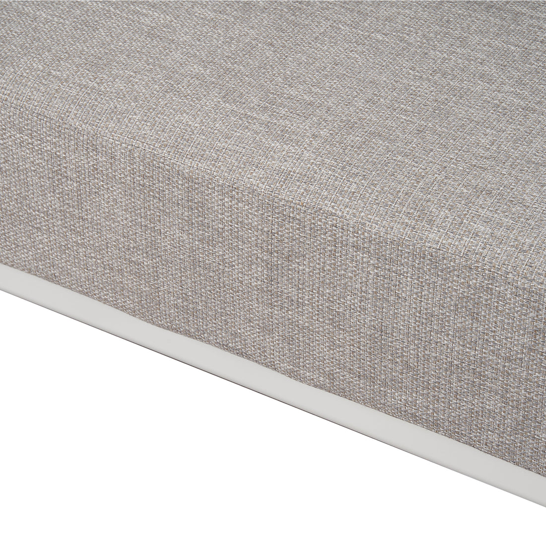 Close-up of the corner and fabric texture of a mattress or cushion on a white background.
