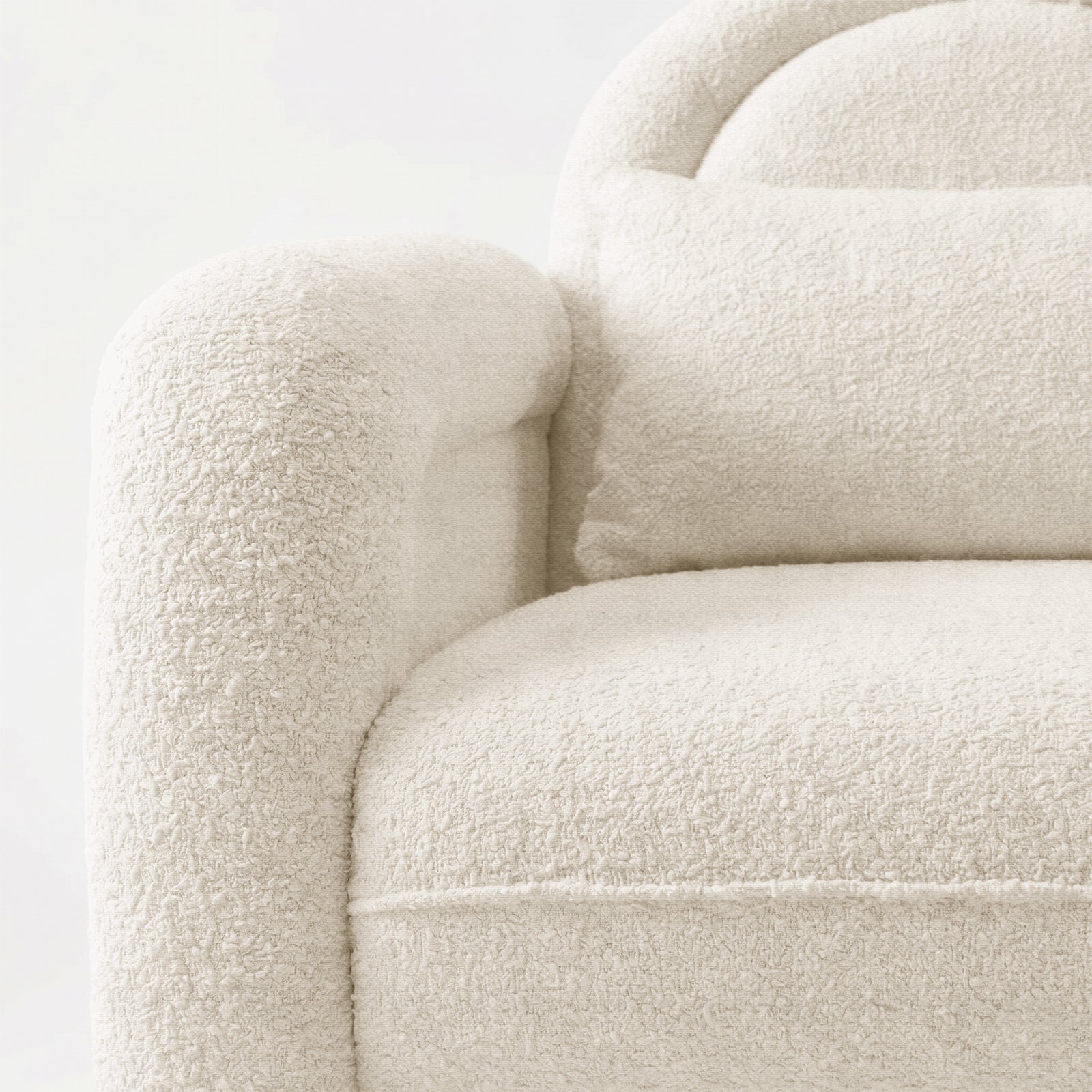 Close-up of plush boucle fabric on armchair against white background