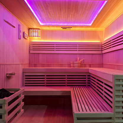 Wooden sauna interior with colorful LED lighting and bench seating in a finished room