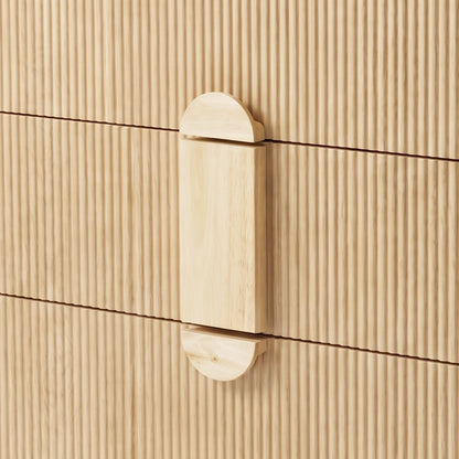 Close-up of wooden handle and fluted front panels