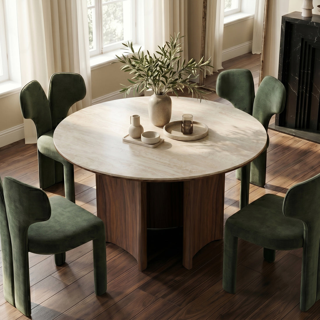 Round dining table with four green chairs in a bright dining room