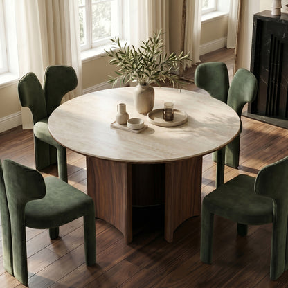 Round dining table with four green chairs in a bright dining room