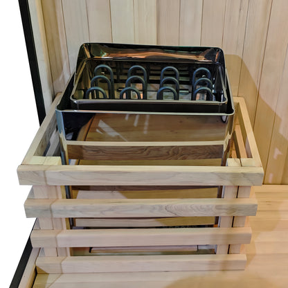 Sauna heater inside a light wood safety guard in a wooden sauna room