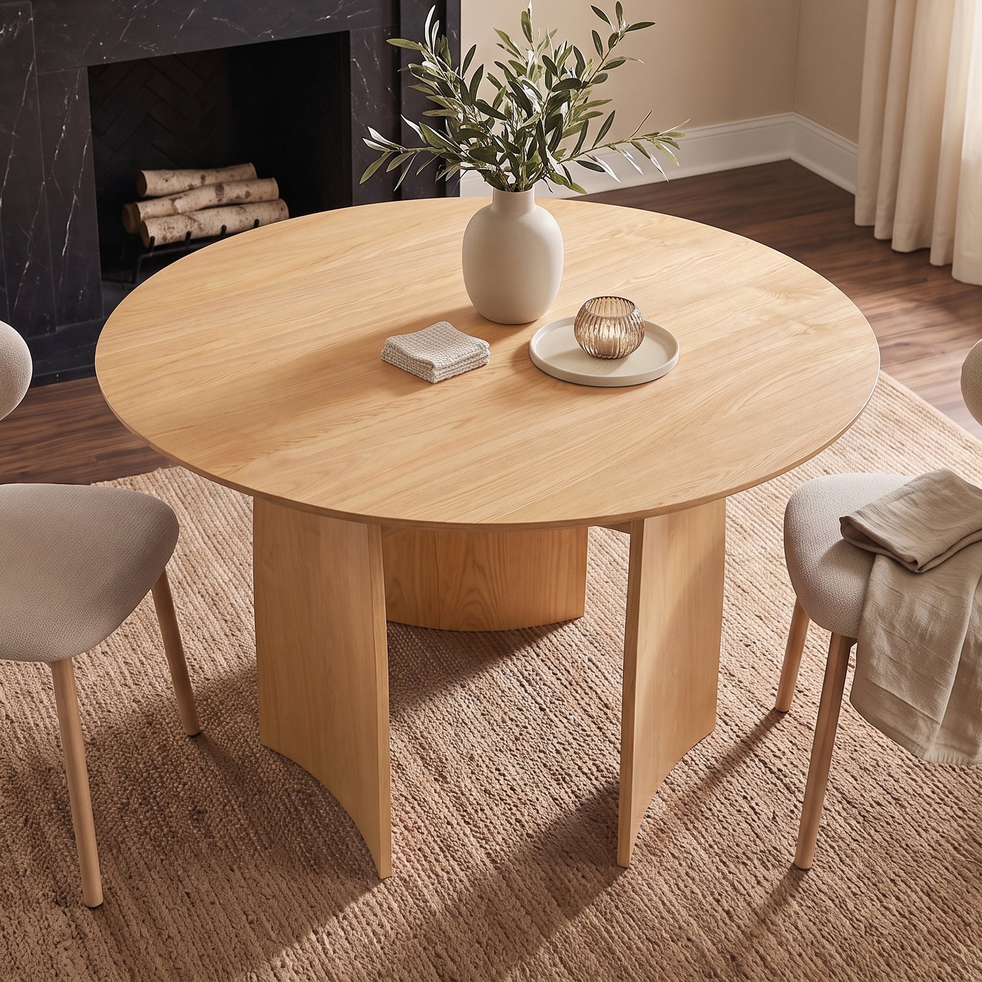 Round wooden dining table styled in a modern dining room