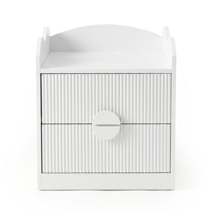 White bedside table with two drawers and oversized circular handle on white background
