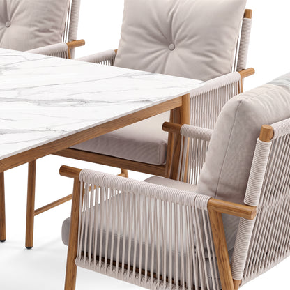 Partial view of a dining set with marble-top table and cushioned chairs on a white background