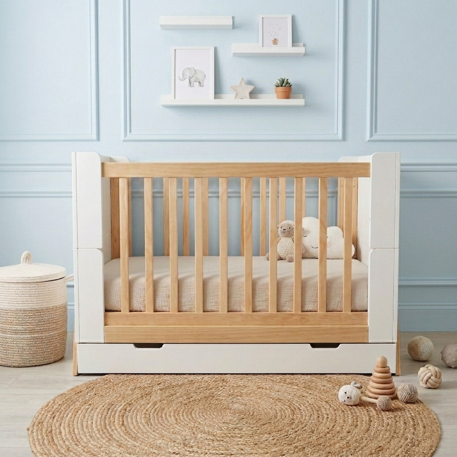 Baby crib in a nursery with blue paneled walls and decor