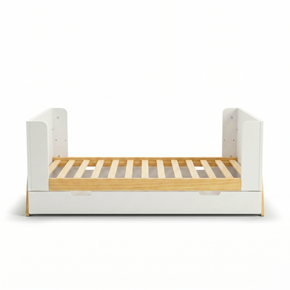 Children’s bed with white frame and wood slats on white background