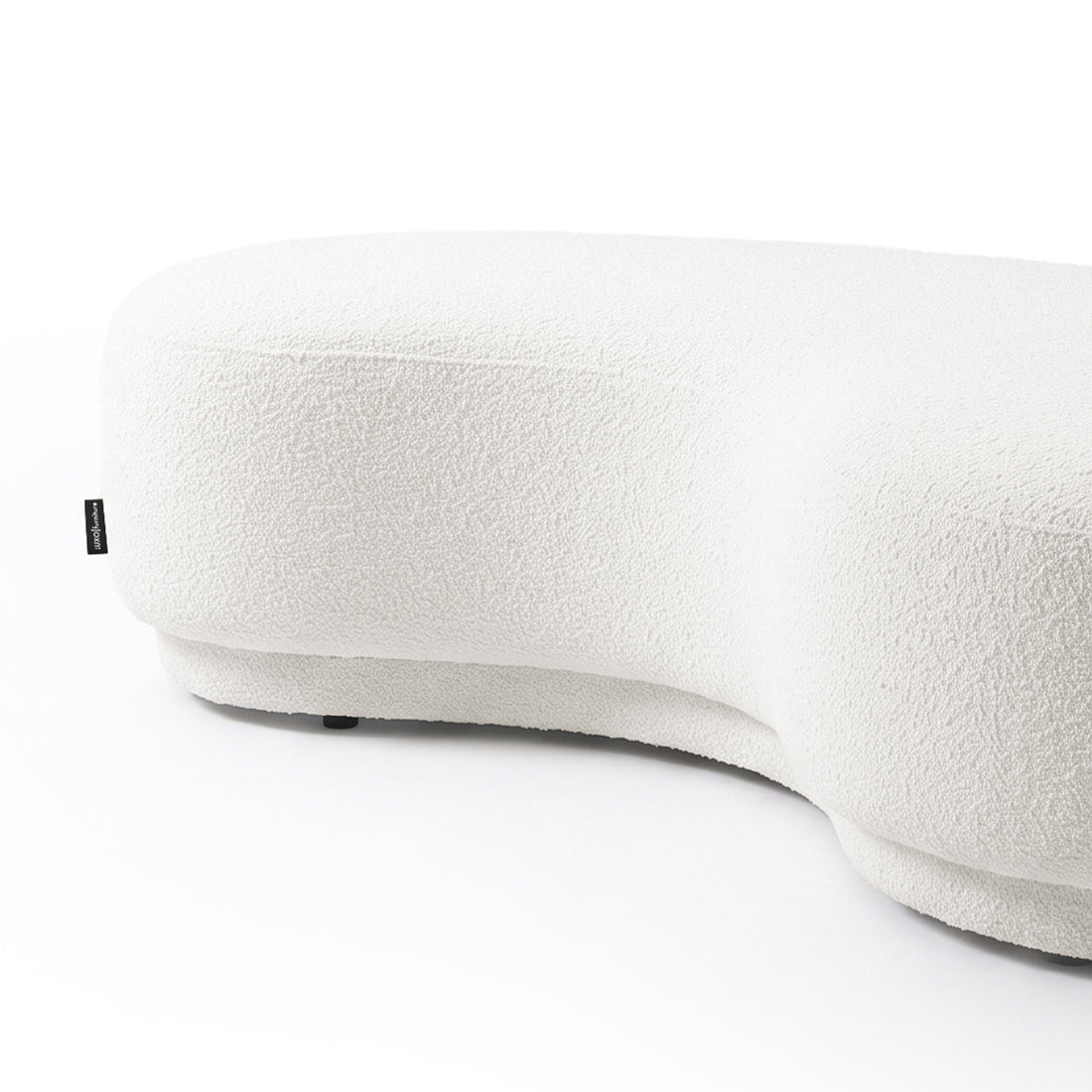 Partially cropped curved upholstered sofa on a white background