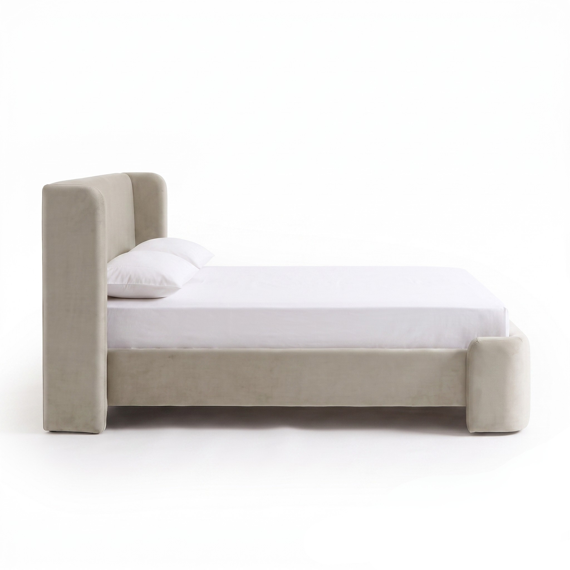 Side profile view of an upholstered bed on a white background